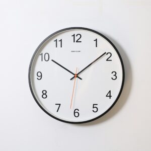 round analog wall clock pointing at 10:09