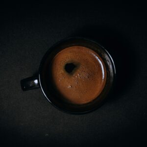 black ceramic mug with brown liquid
