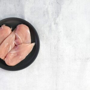 two raw chicken breasts in a black bowl