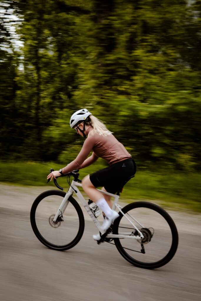 A woman riding a bike down a street